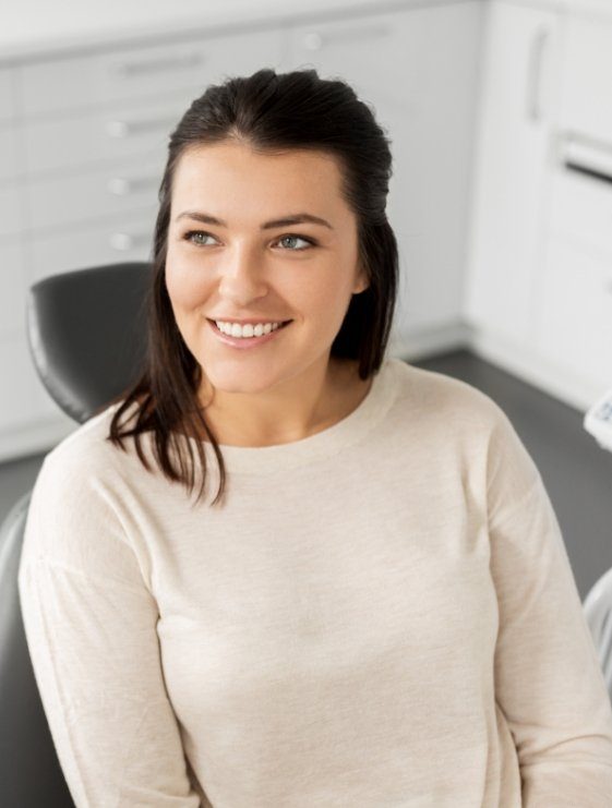 Smiling woman sitting in dental chair