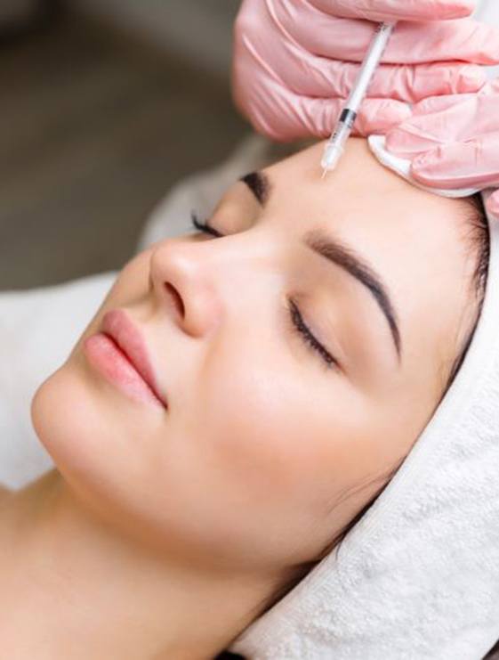 Woman receiving BOTOX injection between her eyebrows