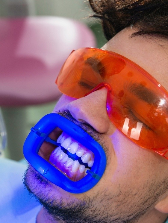 Man receiving professional teeth whitening from cosmetic dentist