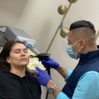 Doctor Aldana giving a patient a facial aesthetic treatment