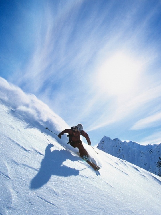 Person skiing down a snowy mountain