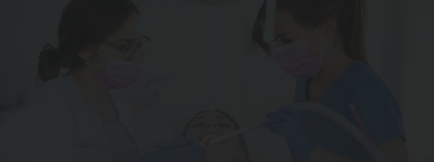 Two cosmetic dentists treating a patient