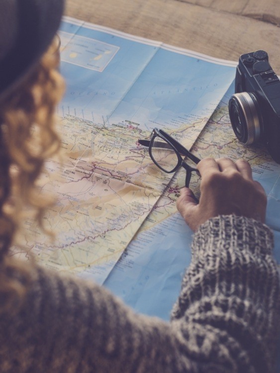 Woman sitting at desk and looking at a map